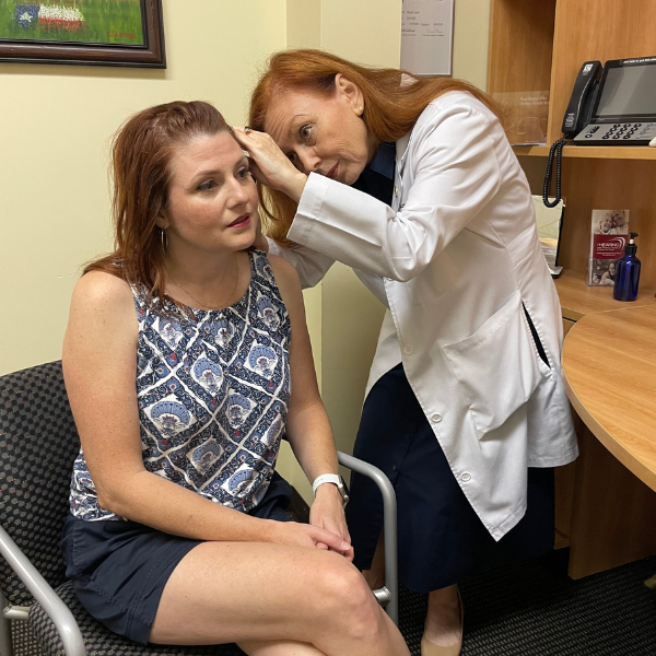 Dr. Land checking a patient's ear